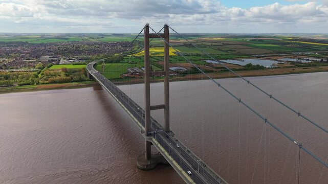 Close up aerial view of the Humber Bridge suspension cables and towers with busy road traffic UK