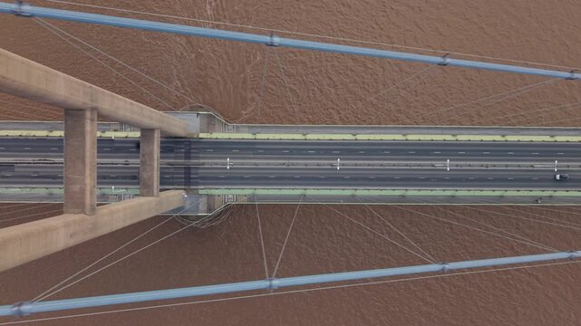 High angle view of road traffic driving across the Humber Bridge in East Yorkshire UK