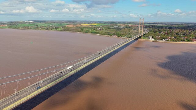 High angle view of road traffic driving across the Humber Bridge in East Yorkshire UK