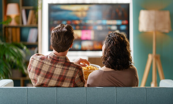 Couple Relaxing at Home Watching TV with Popcorn, Cozy Modern Living Room