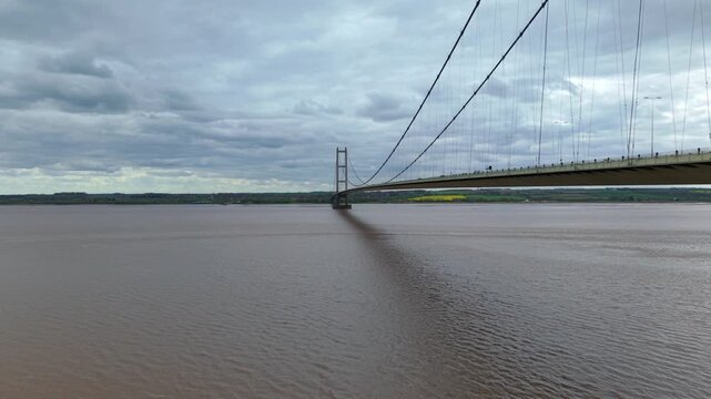 Drone perspective capturing the iconic Humber Bridge spanning muddy estuarine waters