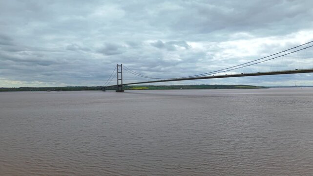 Drone perspective capturing the iconic Humber Bridge spanning muddy estuarine waters