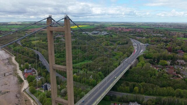 High angle tracking view of vehicles driving over the historic Humber Bridge highway crossing in England