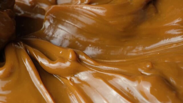 Macro texture of dulce de leche. Thick caramel sauce