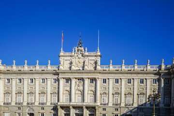 Obraz premium Royal Palace of Madrid,Spain,Facade of a grand neoclassical palace under a clear blue sky