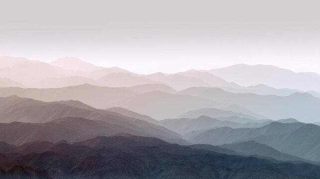 Landscape photograph of a mountain range. the mountains are covered in a layer of fog or mist, creating a hazy and misty atmosphere.