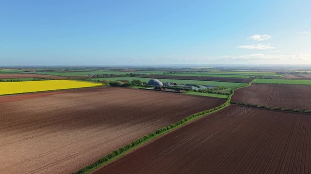 Aerial view of a renewable biogas energy production power plant in rural colourful agriculture fields in Lincolnshire UK