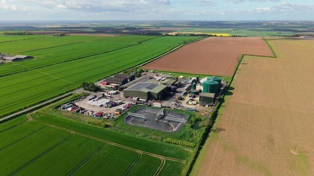 Aerial view of a renewable biogas energy production power plant in rural colourful agriculture fields in Lincolnshire UK