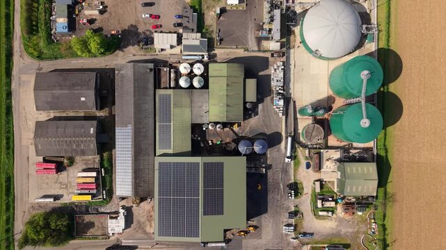 Top down aerial view of busy industrial activity and vehicle movement at a biogas renewable energy site in the UK