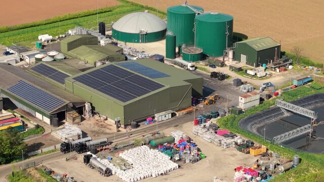 Aerial view of an anaerobic digester facility and biogas domes surrounded by colorful fields in Lincolnshire UK