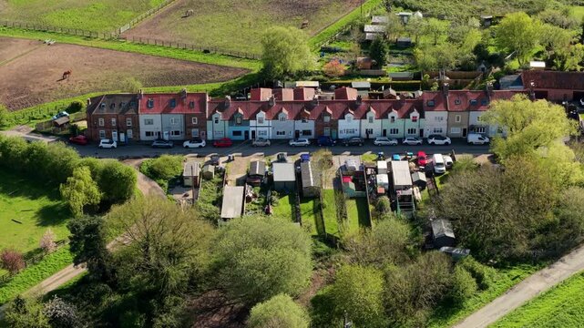 Aerial View of a Single Row of Residential Houses Along a Country Road in the Rural Countryside