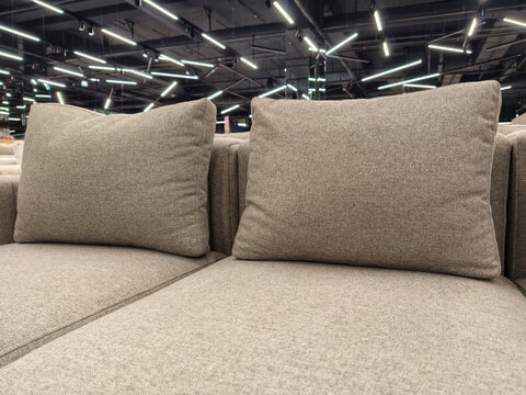 Elegant gray sofa with oversized cushions, available for sale in a furniture store