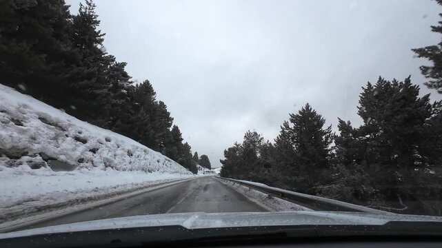 Driving a car on a snowy mountain road in La Molina Pyrenees