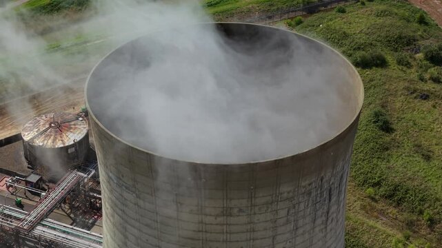 Close up aerial view of a concrete cooling tower with steam rising at Saltend Chemicals Park in Hull UK