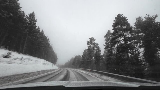 Driving a car on a dangerous snowy road in La Molina, Pyrenees