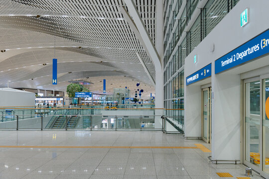 April 20, 2026, Incheon, South Korea - Interior view of Incheon International Airport Terminal 2 departures area with escalators and signage.
