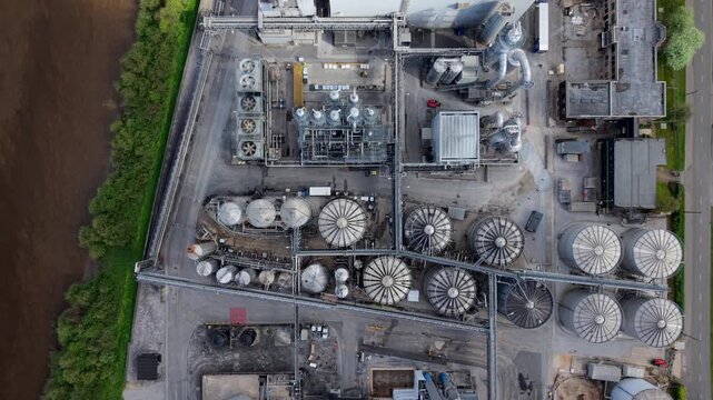 Aerial view of an industrial manufacturing factory with silos and piping on the banks of the River Aire UK