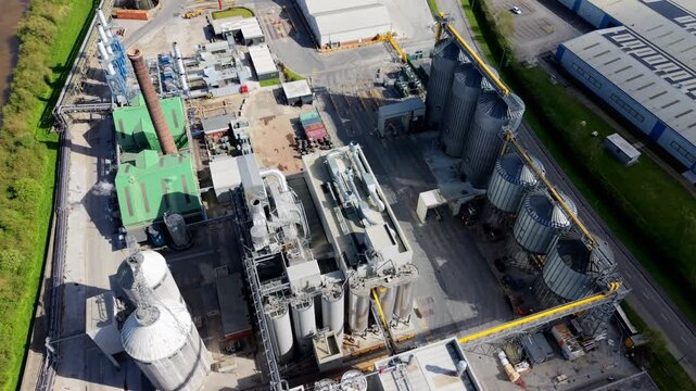 High angle abstract view of chemical processing plant machinery, metal pipes, and manufacturing equipment