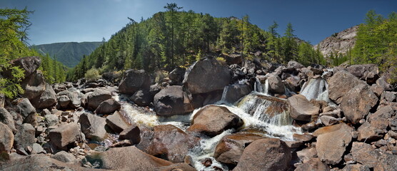 Russia, Western Buryatia, Eastern Sayan Mountains. A picturesque panorama of the Dabata mountain river rushing from the mountains at a 45-degree angle in countless cascades among huge boulders. © Александр Катаржин