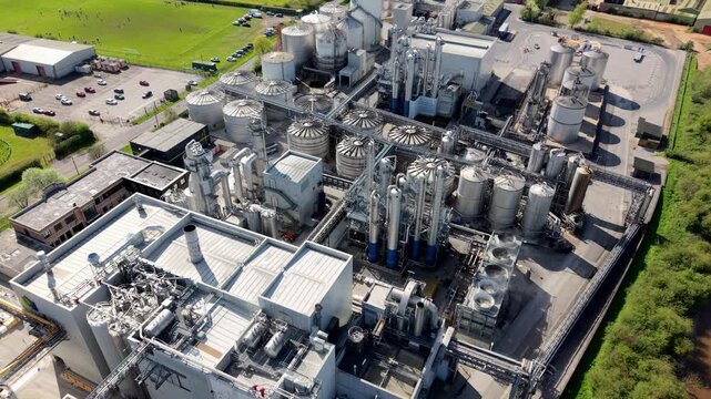Close up aerial view of industrial manufacturing infrastructure with piping and silos in Yorkshire UK