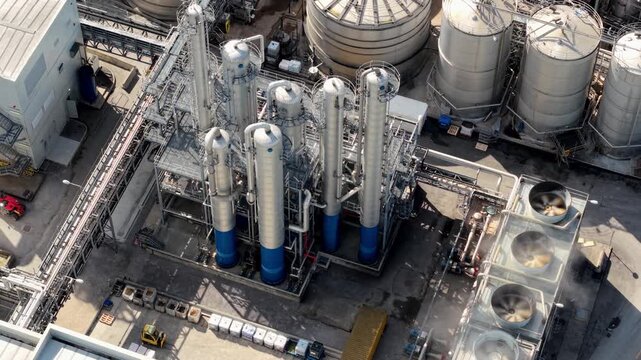Close up aerial view of industrial manufacturing infrastructure with piping and silos in Yorkshire UK