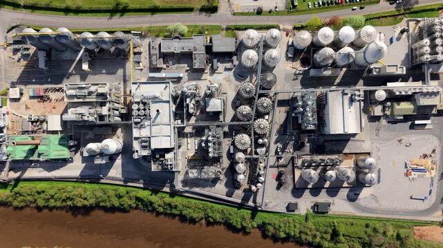 Close up aerial view of industrial manufacturing infrastructure with piping and silos in Yorkshire UK