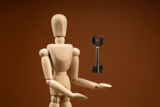 Artist doll with outstretched arm under floating door key, access and liberation theme
