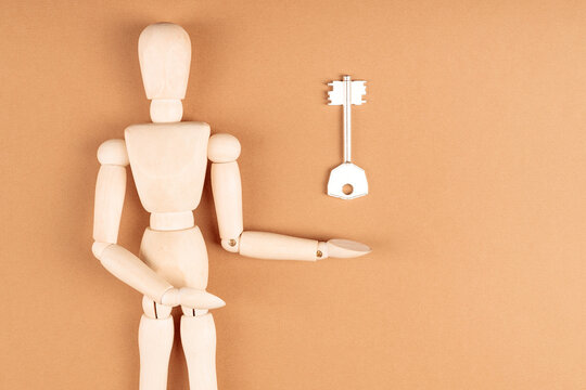 Wooden mannequin reaching toward key above, solution and opportunity concept