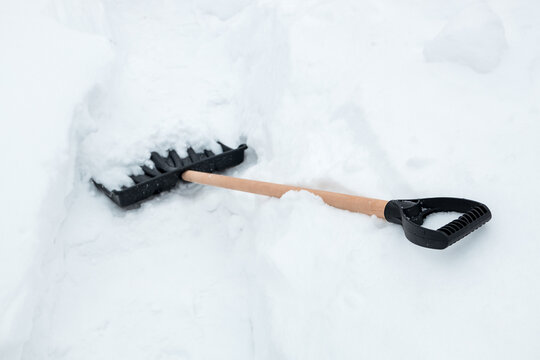 Post-snowfall scene with shovel planted in accumulated snow