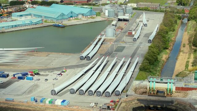 Aerial drone view of wind turbine blades laid out at a port facility in Hull UK