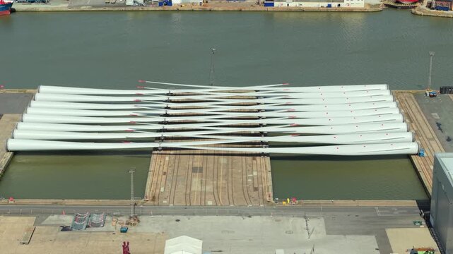 Aerial drone view of wind turbine blades laid out at a port facility in Hull UK