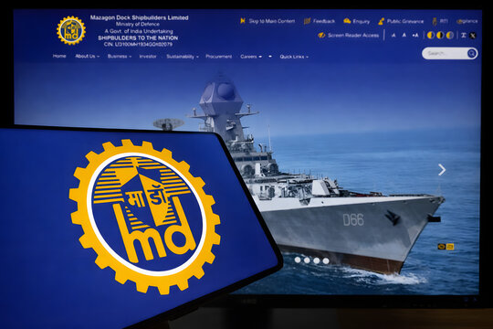 Mazagon Dock Shipbuilders Limited website displayed on desktop screen featuring naval warship, Indian defence sector and shipbuilding PSU company investment concept