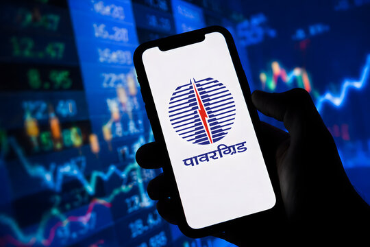 Power Grid Corporation logo on smartphone with live stock market chart and data in background, Indian PSU power sector investment and equity market trading concept