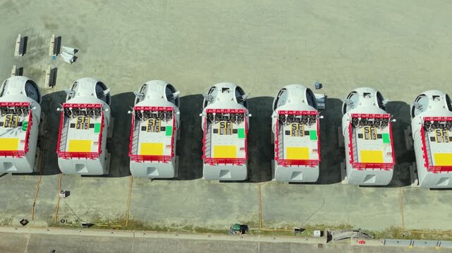 Close up aerial view of wind turbine nacelles lined up on a dock in a construction yard in Hull UK