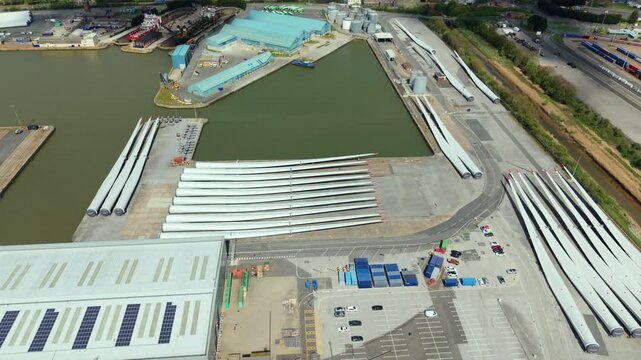 Aerial drone view of wind turbine blades laid out at a port facility in Hull UK