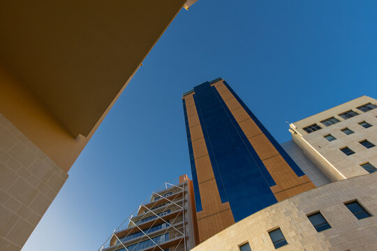 St. Julian's, Malta - December 25, 2025: Portomaso Business Tower highlights its glass facade against the Mediterranean sky in Malta's central business hub.