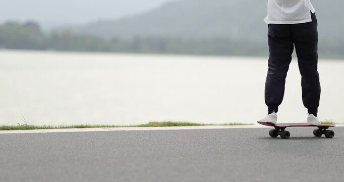 Woman skateboarding at the seaside
