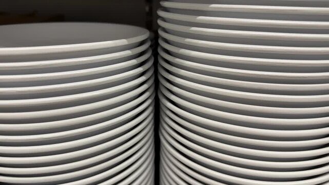 Stack of white ceramic plates creating a seamless pattern in a kitchen supplies background