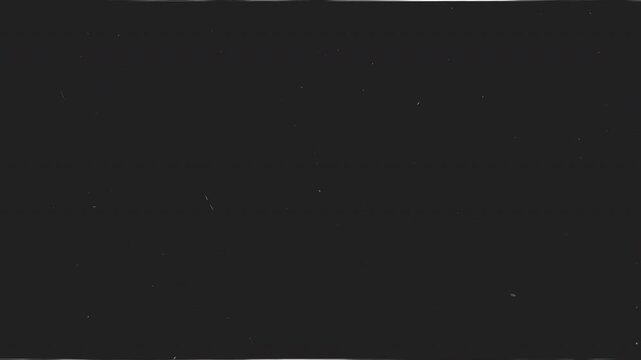 Dark old film grain texture with subtle dust particles and vintage background for overlay and video editing