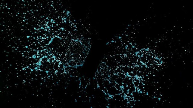 Super Slow Motion of Splashing Water on Black Bottle Shape. Filmed on High Speed Cinema Camera, 1000 fps.