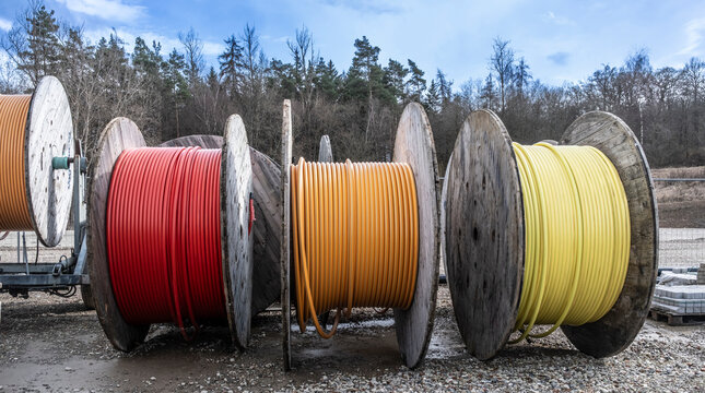 Fiber optic cables on wooden cable drums at construction site
