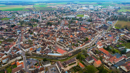 Fototapeta premium Aerial of the old town of Nuits-Saint-Georges in France on a cloudy morning in early spring.