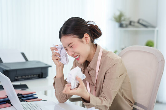 frustrated Asian businesswoman crying stress overwhelmed emotion difficult situation working home office desk using laptop computer tears depression anxiety