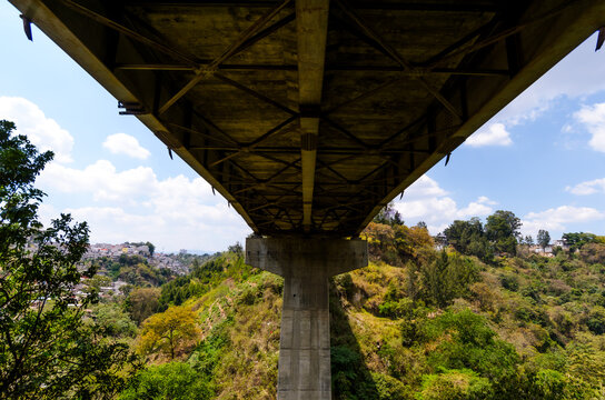 Perspective from the bottom of a bridge showing the density of urban settlements.