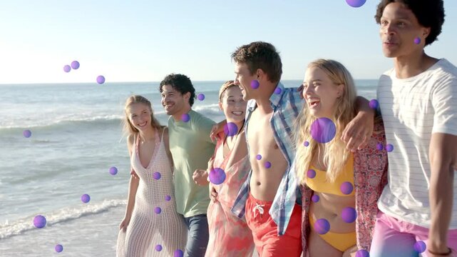 Group walking on shore, man pointing to horizon, purple spheres overlaying for travel