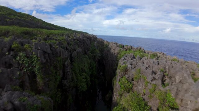 FPV Drone Flying Over Volcanic Coast and Waves in Niue