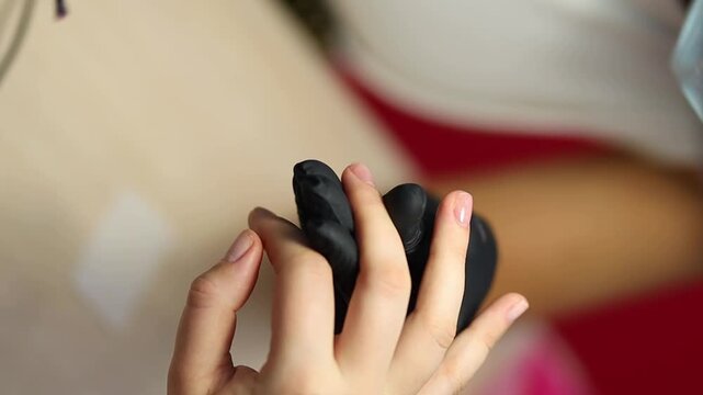 Women's manicure. Female hand undergoing a manicure procedure. The master does a women's manicure. A manicurist files a women's nails in a salon. Hygiene and hand care for woman. manicure design.
