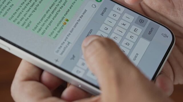 Man hands chatting and typing on smartphone macro closeup. Unrecognisable human typing text message tapping touchscreen keyboard using WhatsApp application, a social media.