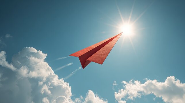 premium Red paper airplane flying in the blue sky towards the bright sun with clouds and motion trails background