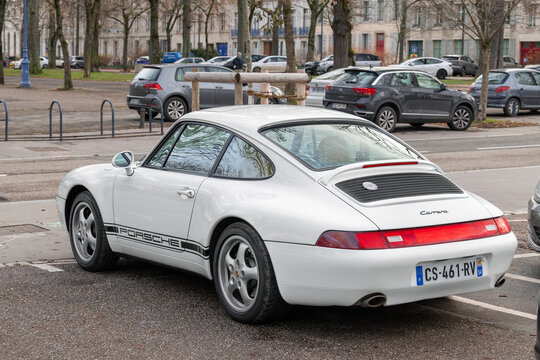 Nancy, France - December 5th 2025 : View on a white Porsche 993 Carrera parked on a street.